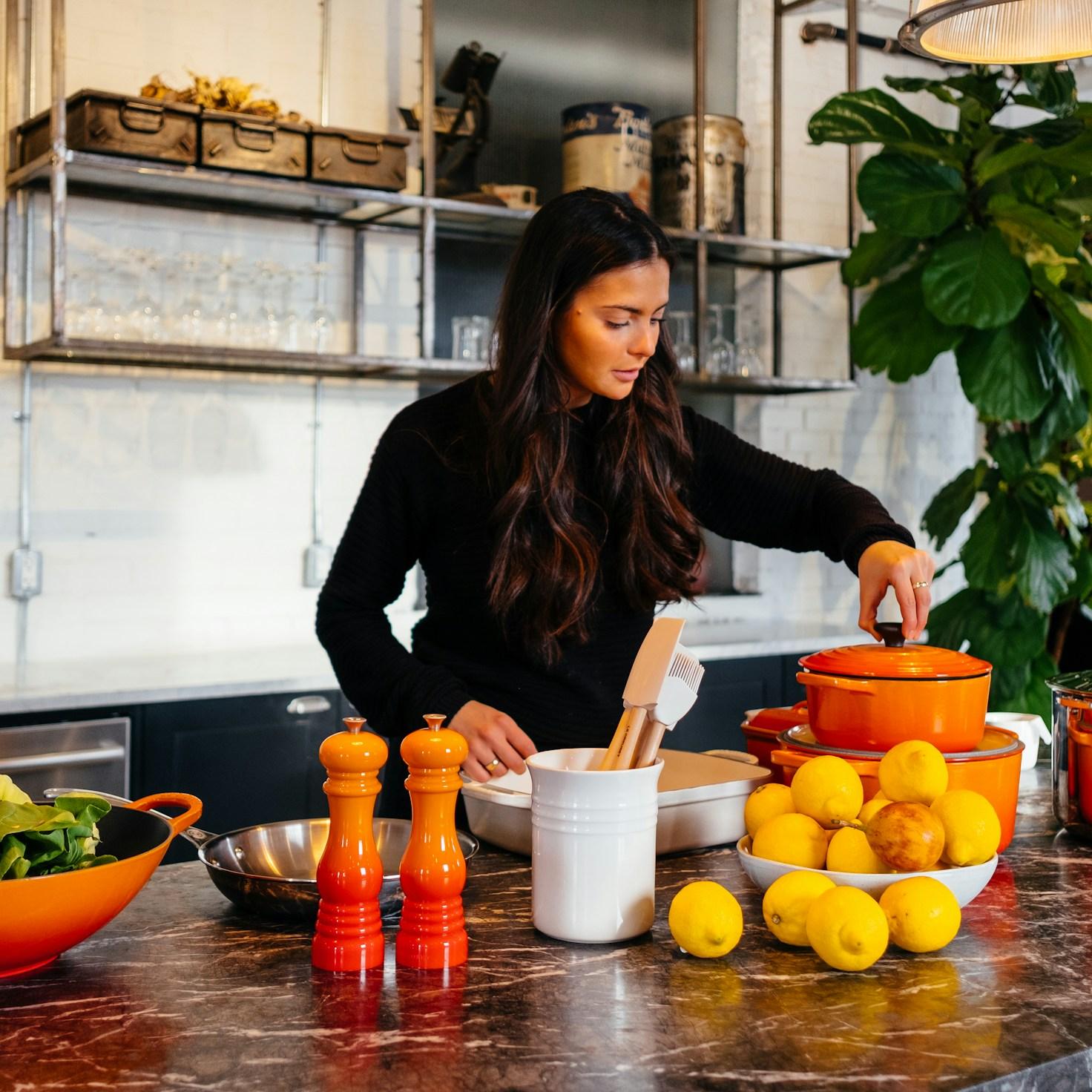 Community members collaborating in a modern kitchen space, sharing recipes and cooking techniques